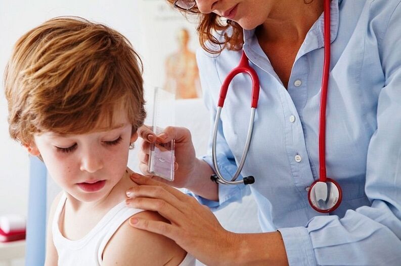 doctor examines a child with papillomas in the body